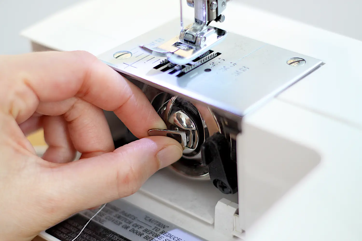 putting bobbin case in sewing machine